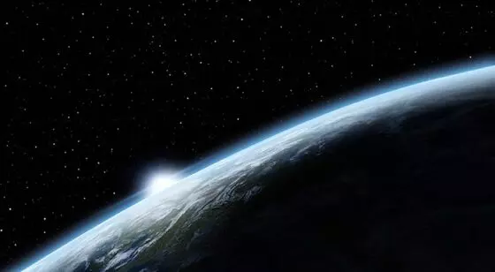 Space view of earth with the sun on the horizon
