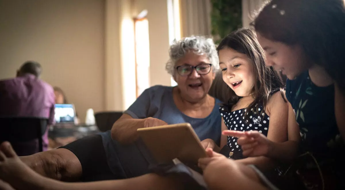 Grandmother and granddaughter on a video call with a digital tablet at home