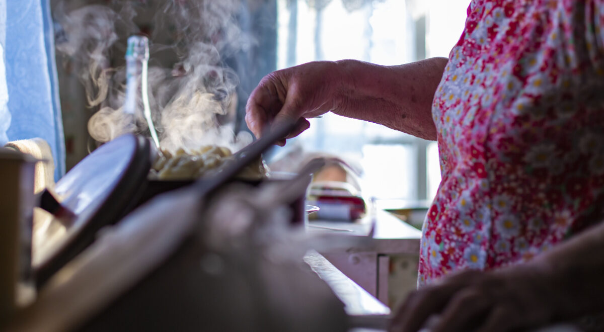 hands of an old grandmother preparing dinner for her grandchildren