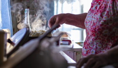 hands of an old grandmother preparing dinner for her grandchildren